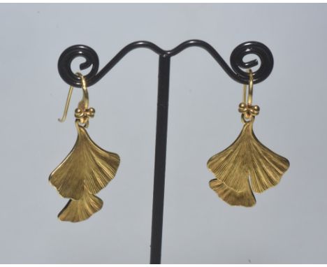 A pair of vintage silver-gilt drop earrings, each modelled as two articulated stylised leaves, fish hook fitting. Length 36mm