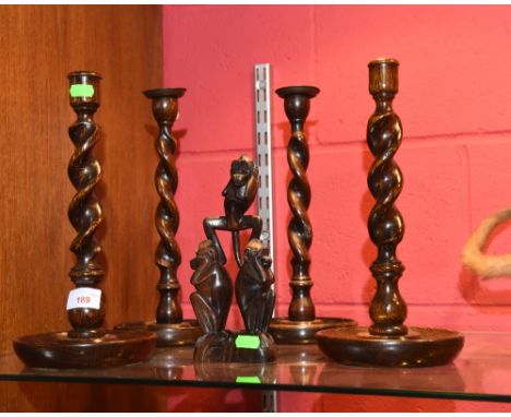 Two pairs of oak barley twist candlestick; tog. with a carved group of monkeys