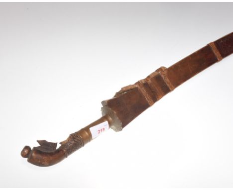 A Middle Eastern brass hilted sword in a wooden scabbard