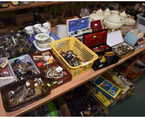 Ten trays and boxes comprising a large quantity of costume jewellery, wristwatches, badges, vintage spectacles, pipes etc