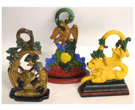 Three good quality cast iron painted doorstops, one modelled with a fox head and riding boots, the other a lion, the other wi