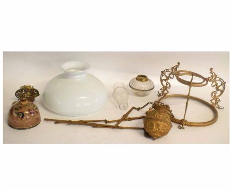 Victorian hanging adjustable oil lamp supported on three scrolling pierced columns with an opaque shade with decorative font 