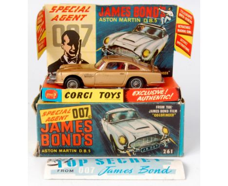 Corgi Toys, 261 James Bond's Aston martin DB5, gold body, red interior with wire wheels, 1 bandit figure, mechanisms in worki