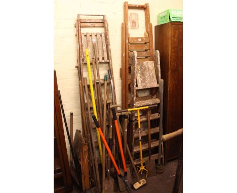 Three pairs of vintage wooden steps, step stool and collection of long handled tools.