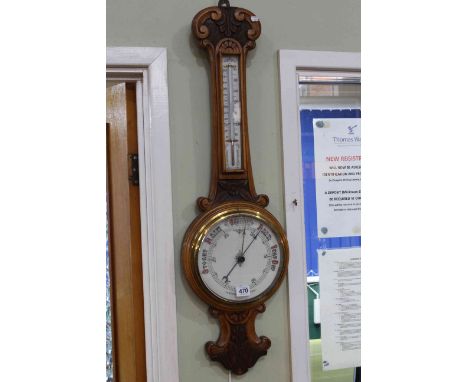 Carved oak aneroid barometer and thermometer, 86cm height.