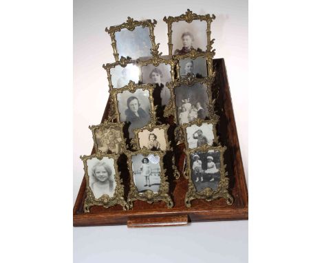 Collection of thirteen ornate cast brass easel photograph frames, largest 23cm by 16cm.Condition: Dusty but sound.