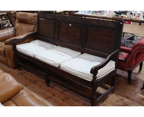 18th Century oak settle with three raised panel back and on turned legs with stretchers, 183cm wide. Quite sturdy but showing