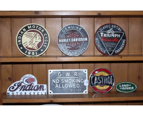 Seven cast metal advert signs including two Indian Motor Cycle signs, Harley Davidson, Triumph, etc.