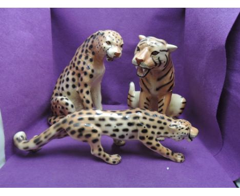 Three ceramic studies, seated lion and cheetah and a stalking cheetah