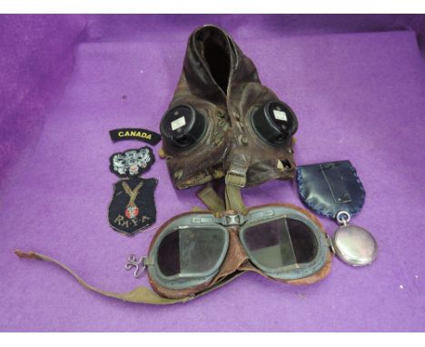 A vintage RAF leather flying helmet with goggles, a vintage compass and cloth badgesENGRAVING DICKIE S.R.S DRAKE 