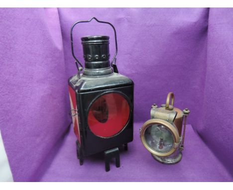 A railway post/signal lamp having red and clear lenses and red and white checkered sides along with a LNER Lucas King of the 