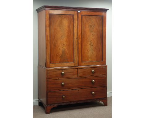 Early 19th century mahogany linen press, two figured panelled doors enclosing linen slides, two short and two long drawers, r