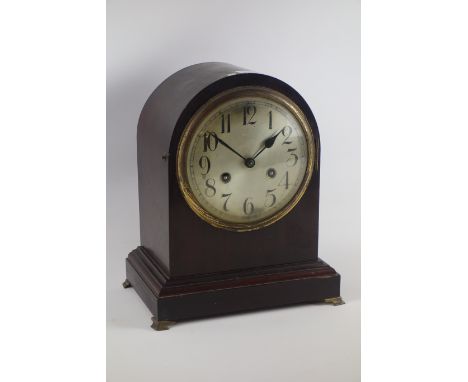 20th century arched top mantel clock, circular Arabic dial , twin train Junghans movement striking the half hours, brass beze