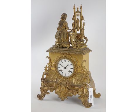 Late 19th century ornate gilt metal mantle clock, maiden kneeling reading the bible in gothic church, French barrel movement,