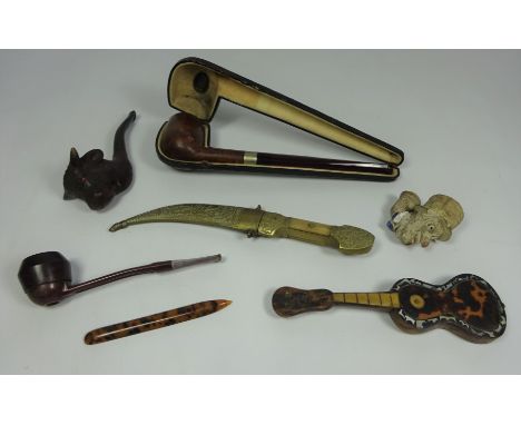 Tortoiseshell model of a guitar, carved wooden pipe in the form of a bulls head, two walnut pipes, French pottery pipe in the