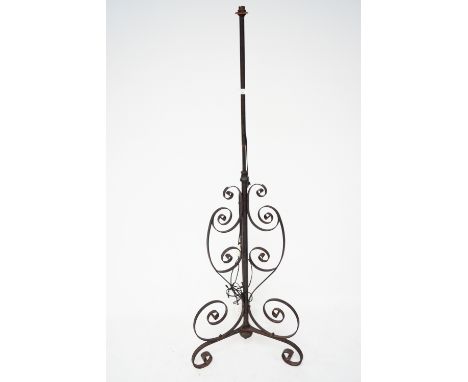 A 20th century cast iron standard lamp. With scrolling tripod supports, measuring approximately 167cm high