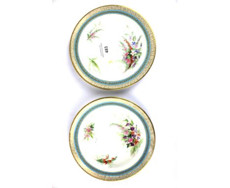 Two 19th century Royal Worcester plates. Both painted with sprays of flowers within a light blue and gilt border with gilt en