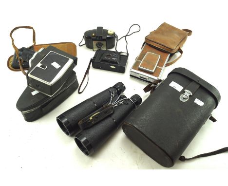 An assortment of cameras and binoculars, To include a Polaroid SX-70 land camera, Kodak six-16 junior camera etc Condition Re