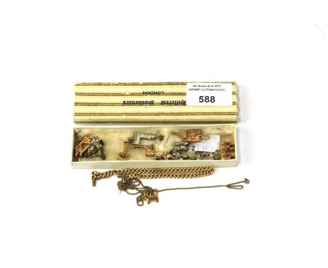 A yellow metal chain and a selection of vintage charms. The chain unmarked, the charms mainly depicting landmarks
