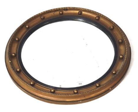 A reproduction regency style bevelled edge wall mirror. Of circular form with a gilt frame, Diam 60cm 