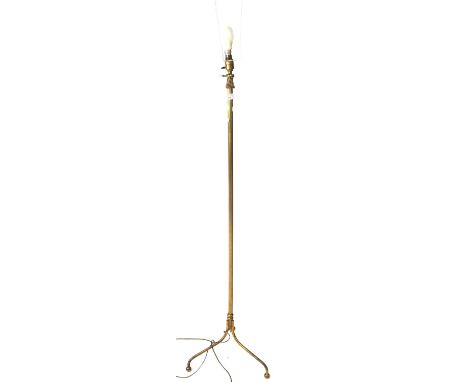 A 20th century brass standard lamp. Of ribbed columned form, on tripod supports, approximately 137cm high