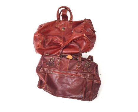 Two vintage leather Gladstone bags. The largest measuring approximately 68cm long