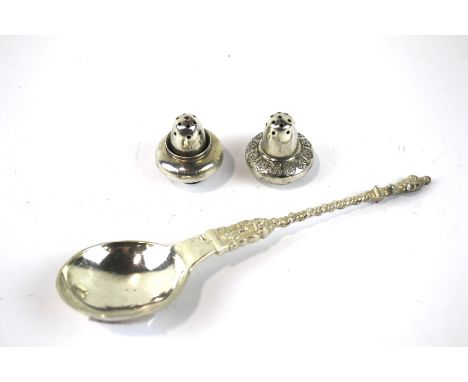 Three pieces of Russian silver. Comprising a pair of shakers and a spoon, the spoon decorated with figures and topped with an