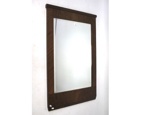 A mid century walnut veneer Art Deco wall mirror. Of rectangular form, with bevelled edge, measures approximately 76cm x 121c