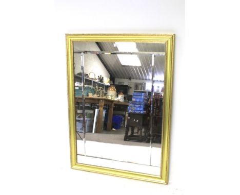 A modern large gilt framed wall mirror. The mirror made up of five pieces with bevelled edges. 111cm x 81cm