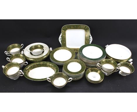 Two almost identical part Wedgwood dinner services, one marked 'Harlech'. Decorated with gold on green borders, including din