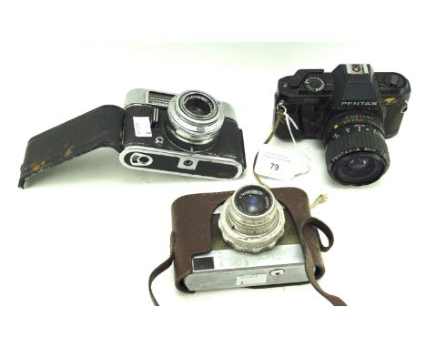 Three vintage cameras. Comprising a Pentax P30, Voigtlander no.A.P.0553/162085 and a Carl Zeiss Jena no.4284975 Condition Rep