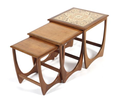 A nest of three mid-century Nathan teak occasional tables. With tile top, raised upon U-shaped supports and stretchers, the l