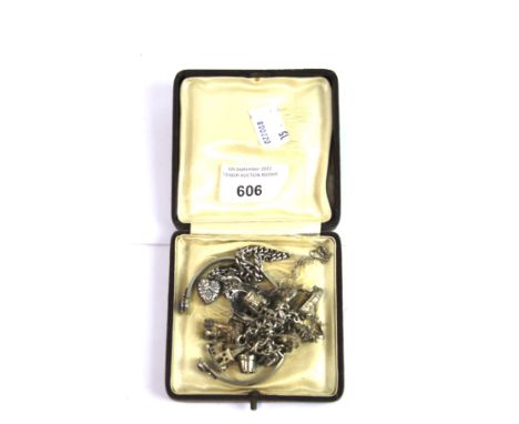 A silver charm bracelet, a silver art nouveau pendant on chain, fixed bangle and another charm bracelet