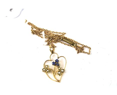 A vintage yellow metal pendant on chain. The pendant of floral form, gem set, both the chain and pendant stamped 9ct, approxi