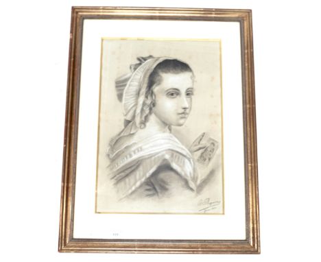 An Edwardian charcoal portrait. Depicting a young woman, signed and dated 'J. Haquins, 1904', 32cm x 46.5cm, framed and glaze