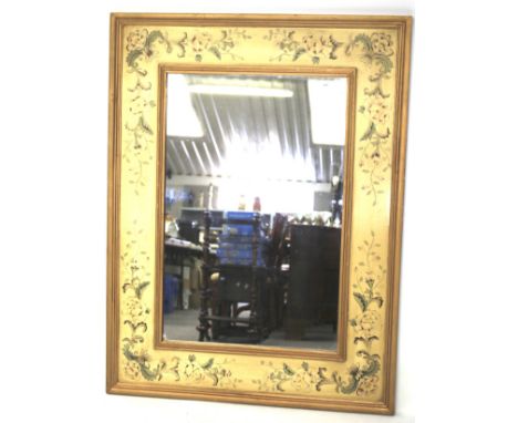 A large contemporary mirror. Of rectangular form, the wooden frame decorated with flowers on a cream ground and a gilt edge, 