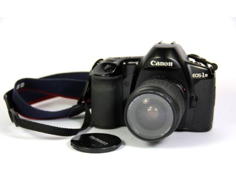 A Canon EOS-1 single lens reflex digital camera with Canon zoom lens.