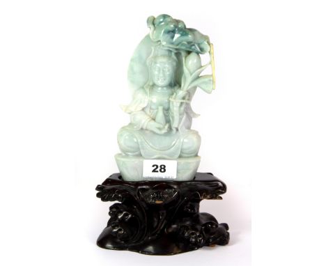 A fine Chinese carved mixed colour jade figure of the Goddess Guan Yin, with carved wooden stand and unusual natural yellow d