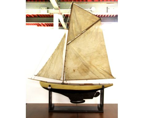 A large vintage wooden pond yacht and stand, L. 122cm, H. 153cm.