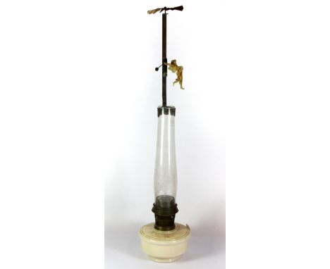 A very unusual heat operated acrobat automaton attached to an oil lamp chimney, H. 77cm overall.
