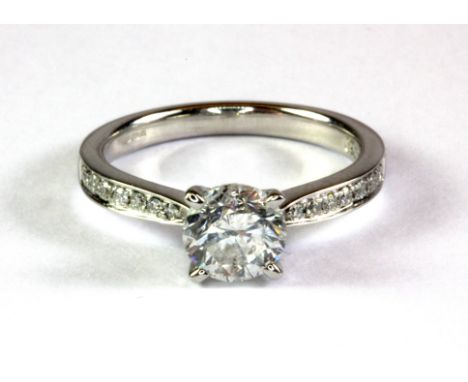 An 18ct white gold (stamped 750) solitaire ring with diamond set shoulders, centre diamond approx. 1.16ct, colour E-F, clarit