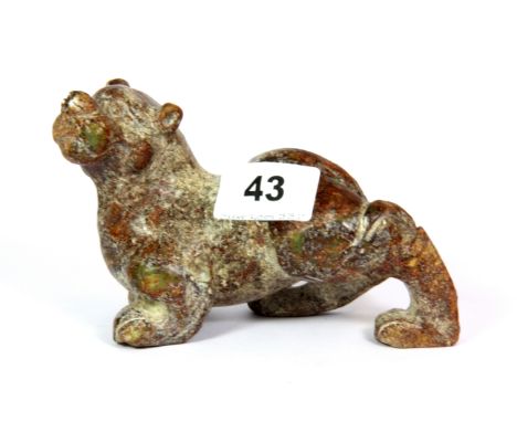 A 19th / early 20th century Chinese carved mixed colour jade /  hardstone figure of a tiger, L. 14cm, H. 9cm.