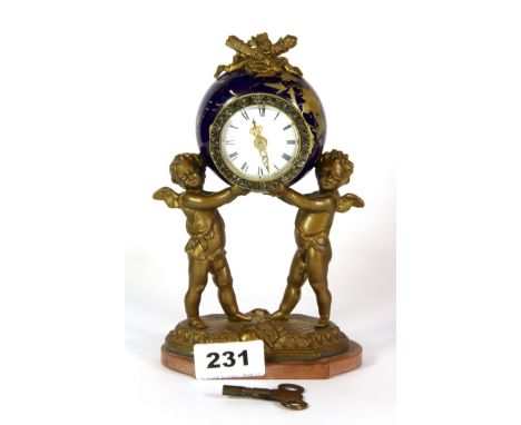 An early 20th century gilt porcelain and gilt metal cherub mantle clock, H. 19cm.