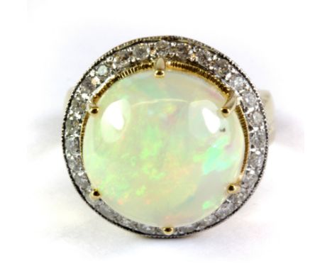 A yellow metal (tested 18ct gold with foreign mark) domed opal and diamond ring (N.5).