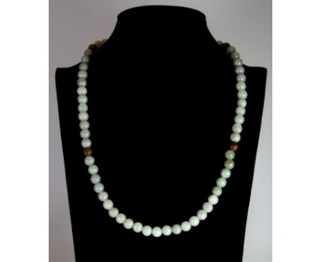 A polished jade bead necklace.