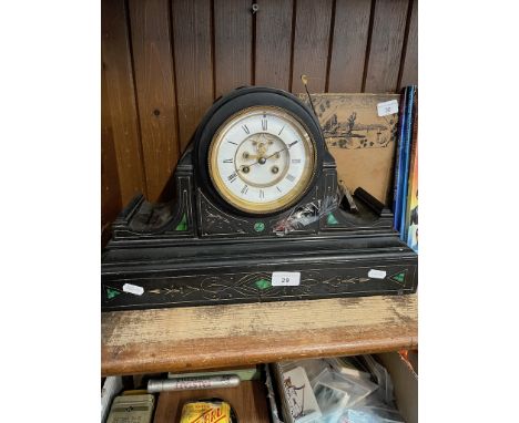 A black slate mantle clock with key and pendulumThe plates around the base of the clock are cracked and repaired, no other vi