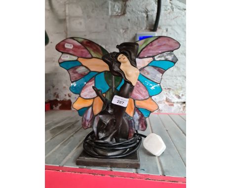 An Art Deco style lamp modelled as a lady with leaded glass butterfly wings.