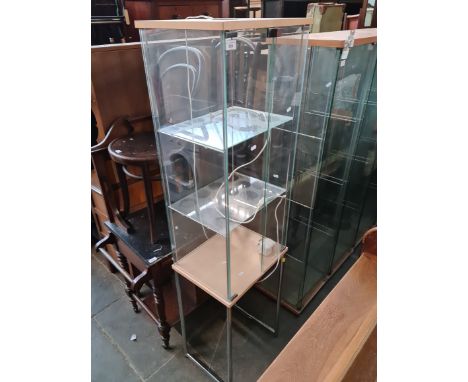 A glass display cabinet with internal light. 