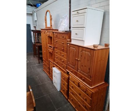 A suite of pine bedroom furniture comprising wardrobe, dressing table, bedside cabinets, two chests of drawers and a pine sid