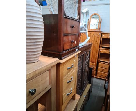 A light oak bedside chest, a mahogany bedside cabinet, a ceramic vase and a brass multi-branch floor light. 